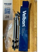 Folded Velbon Sherpa 200R tripod alongside original blue and white Velbon box, showing condition and included packaging.