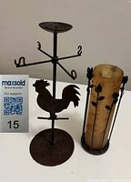 Photo of wrought iron candle holder with rooster and wrought iron vase holder with leaf design