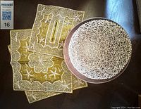 Photo showing gold and white embellished pillow cover and tissue box cover with detailed embroidery.