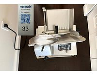 Top view of Eagle Professional electric meat slicer showing slicing blade, food carriage, handle, and control mechanism.