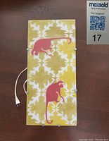 Top view of the painted glass front panel of the night lamp, showing the design with two pink cats on a yellow and white pattern, with white cord and plug visible.