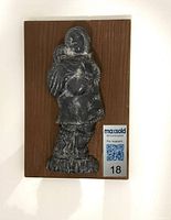 Mother and child wood carving in dark patina mounted on wood panel with MaxSold lot tag visible