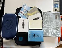 Photo of all items in the lot together: OM Yoga flash cards and booklet, Steadler pencil case, MEC iPad case, Biotherm makeup bag