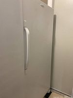 Closed front view showing full white exterior and handle