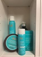 Set of Moroccanoil products showing Beach Wave Mousse, Intense Hydrating Mask, Luminous Hairspray, Hydrating Styling Cream, plus Chromatech Service box.