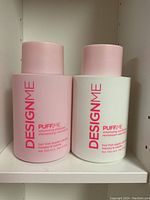 Front view of puff.me volumizing shampoo and conditioner bottles