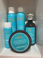 Photo of five Moroccanoil hair styling products grouped on shelf.