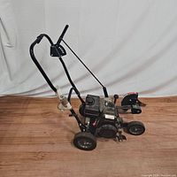Side view of Craftsman 4.0HP edger/trimmer showing engine, wheels, handlebar and blade guard.