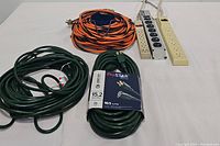 Six electrical items on white background: 3 extension cords and 3 surge protectors, visible details including labels and outlets