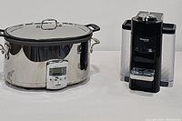 Photo showing both the All-Clad slow cooker and Nespresso VertuoLine coffee machine side by side on a white surface.