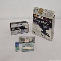 Top-down view of entire lot showing Craftsman drill box, router template set box, hardware in plastic organizer box, nails in blue box, green plastic wall anchors in blister pack