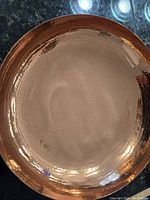 Top view of the hammered copper bowl showing its hammered texture and round shape.