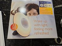 Front of box showing wake-up light and features including natural sounds and sunrise simulation.