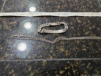 Photo showing both sterling silver bracelet and chain laid flat with a measuring tape for scale.