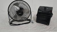 Photo showing Massey table top fan and Holmes small space heater side by side on a white background.