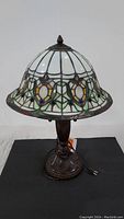 Full view of Tiffany style lamp showing stained glass shade and base