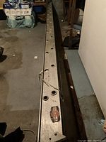 Top-down view showing length and aluminum structure of ladder with spacing holes and brand decal.