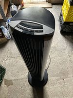 Top view of black and silver Bionair tower fan showing control buttons and rust on air screen.