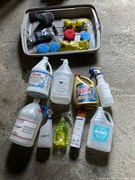 Top view of cleaning sponges and pads arranged in a plastic bin.
