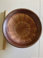 Top view of Japanese Suribachi bowl and wooden pestle, showing interior textured grooves designed for grinding food.