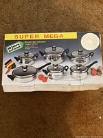Box showing graphic and information of the Super Mega 12-piece stainless steel pot set with lids and pan.