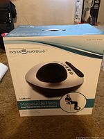 Box of TrueMedic InstaShiatsu foot massager showing product name and model number ES-400 with image of device on front.