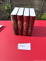 Four Halloween-themed animatronic books standing side by side showing spine details.