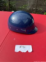 Blue water sport helmet from exterior angle showing glossy finish and ventilation holes.