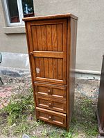Front view of the wooden lingerie dresser showing three drawers and one cabinet door.