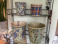 All four planters on a metal shelving unit, top and bottom rows visible