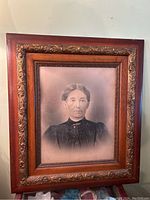 Full frontal photo of the framed Victorian lady portrait, showing the entire artwork and frame with visible wear and marks from age.