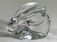 Side profile of hand-blown clear crystal rabbit figurine showing shape and detailed ears with internal bubbles.