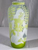 Front view showing kneeling woman in dress surrounded by foliage etched in frosted glass with green accents.