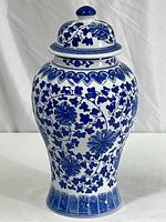 Front view of the blue and white porcelain ginger jar showing the full body and lid with floral pattern.