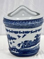 Front view showing detailed Blue Willow pattern on ceramic wall pocket planter.