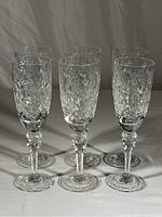 Six clear crystal wine glasses arranged in two rows of three, displaying the Queen pattern with floral and diamond cut designs.