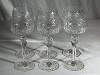All six Rogaska crystal wine goblets shown together, etched floral decor visible; consistent shape and design