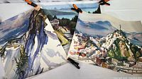 Three posters laid out and clipped, showing mountain ski scene, San Francisco area views, and cityscape.