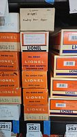Stacked Lionel boxes showing two #6436-110 hopper car boxes alongside others