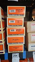 Stack of five Lionel Electric Trains boxes labeled with each train car's name and model number.