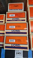 Stack of five boxed Lionel model train cars with Great Northern branding and product labels including Woodside Reefer, Stock Car, and multiple 3-bay hopper cars.