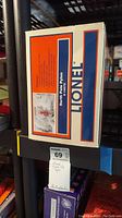Photo of the box for Lionel North Pole Pylon model 14079 on a rack with visible slight damage to the box edges.