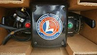 Close-up photo of the Lionel Trainmaster Type ZW transformer control box showing the circular label and control knobs with red and green buttons and a lever