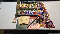 Wide view of all items including patches, insignia, belts, manuals, cards, compass, and pins arranged on table