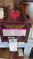 Front and top of original maroon and gold box labeled 'Scale P2 Box Cab Electric Die-Cast Locomotive'