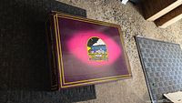 Top of MTH Electric Trains box showing purple lid with logo