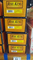 Stack of four Rail King boxes showing product titles and item numbers from MTH Electric Trains.