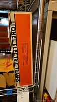 Closed original Lionel Electric Trains box with model label and orange design