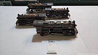 Three Lionel pre-war locomotive engines side by side on table