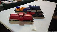 Overview of four Lionel locomotives on table